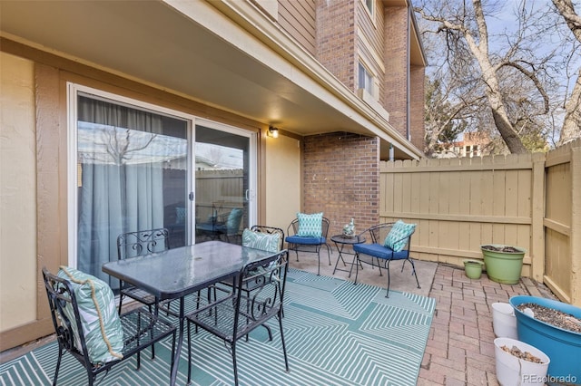 view of patio / terrace featuring outdoor dining area and fence