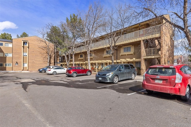 view of property featuring uncovered parking