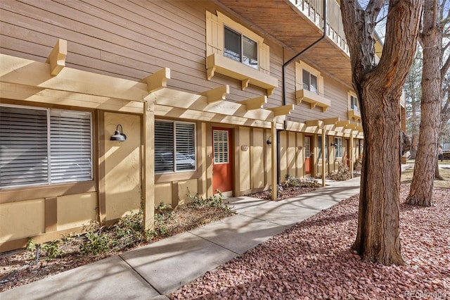 doorway to property featuring a pergola