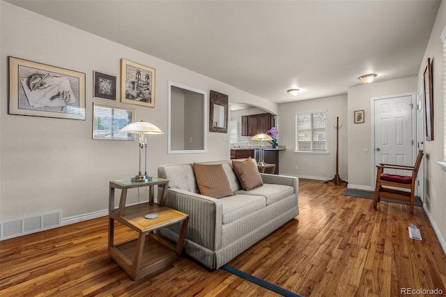 2907 Pennsylvania Ave, Colorado Springs, CO 80907 - living area featuring wood finished floors, baseboards, and arched walkways