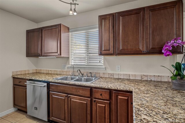 2907 Pennsylvania Ave, Colorado Springs, CO 80907 - kitchen with stainless steel dishwasher, a sink, light countertops, and light tile patterned floors