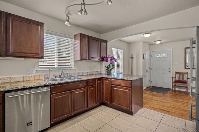 2907 Pennsylvania Ave, Colorado Springs, CO 80907 - kitchen with dishwasher, a sink, light tile patterned floors, and plenty of natural light