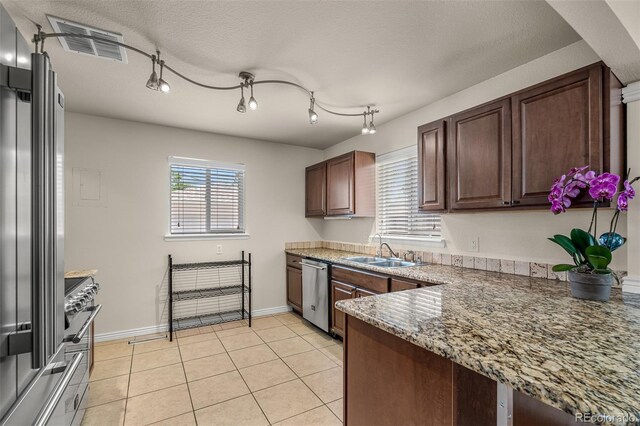 2907 Pennsylvania Ave, Colorado Springs, CO 80907 - kitchen with a sink, stainless steel appliances, healthy amount of natural light, and light tile patterned floors