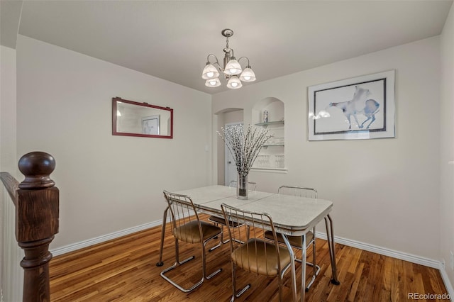2907 Pennsylvania Ave, Colorado Springs, CO 80907 - dining room featuring wood finished floors, baseboards, arched walkways, and a chandelier