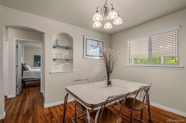 2907 Pennsylvania Ave, Colorado Springs, CO 80907 - dining area featuring wood finished floors, a chandelier, baseboards, and built in shelves