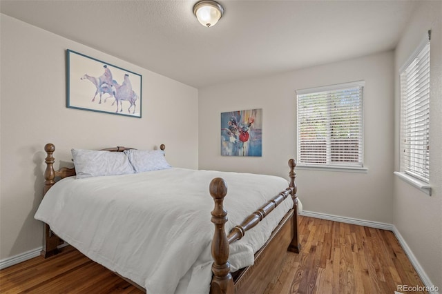2907 Pennsylvania Ave, Colorado Springs, CO 80907 - bedroom with wood finished floors, baseboards, and multiple windows
