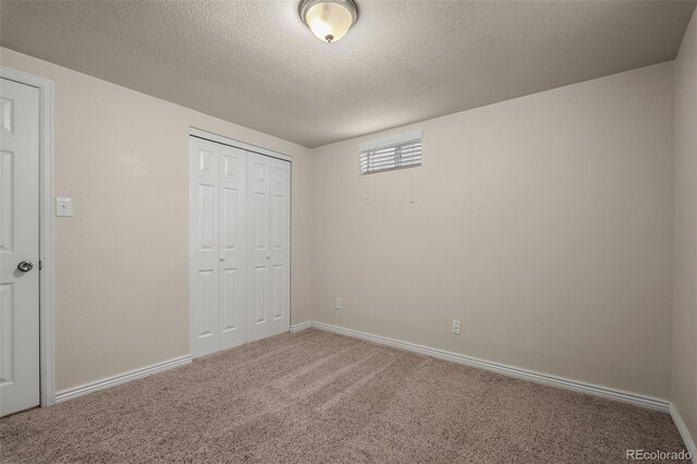 2907 Pennsylvania Ave, Colorado Springs, CO 80907 - unfurnished bedroom with carpet flooring, a closet, baseboards, and a textured ceiling