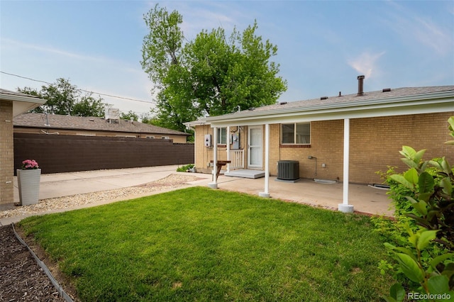 2907 Pennsylvania Ave, Colorado Springs, CO 80907 - rear view of house featuring a patio, brick siding, and central AC unit