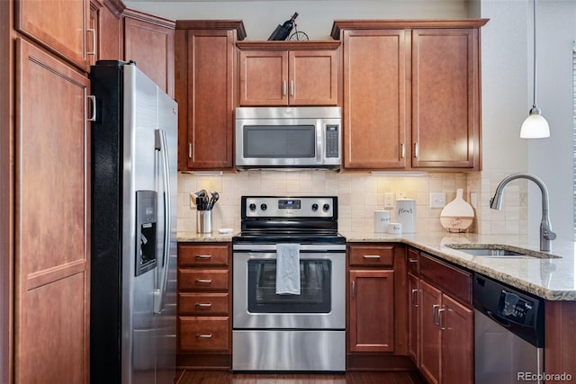 kitchen with a sink, stainless steel appliances, backsplash, and light stone countertops