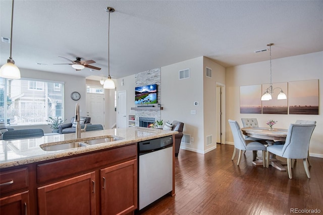kitchen featuring a sink, stainless steel dishwasher, open floor plan, and visible vents