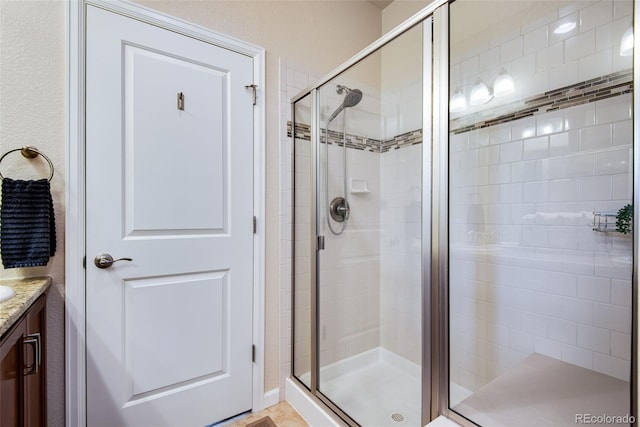 bathroom featuring a shower stall and vanity