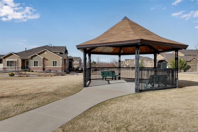 exterior space featuring a yard, a gazebo, and a residential view