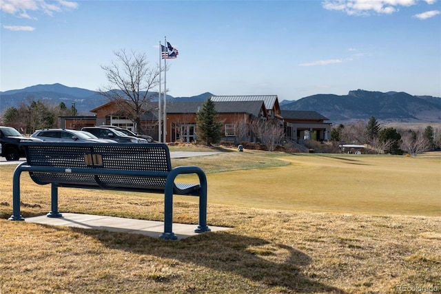 surrounding community with a mountain view and a lawn