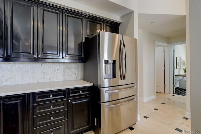 2500 E Cherry Creek S Drive 306, Denver, CO 80209 - kitchen featuring stainless steel fridge, dark cabinets, decorative backsplash, and light countertops