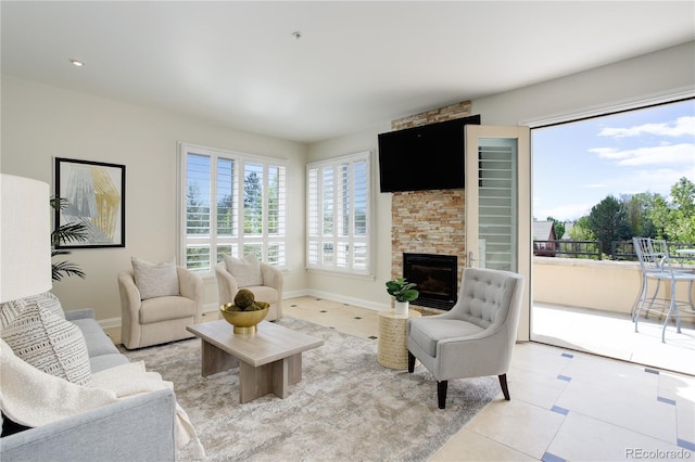 2500 E Cherry Creek S Drive 306, Denver, CO 80209 - living area with light tile patterned floors, a stone fireplace, and baseboards