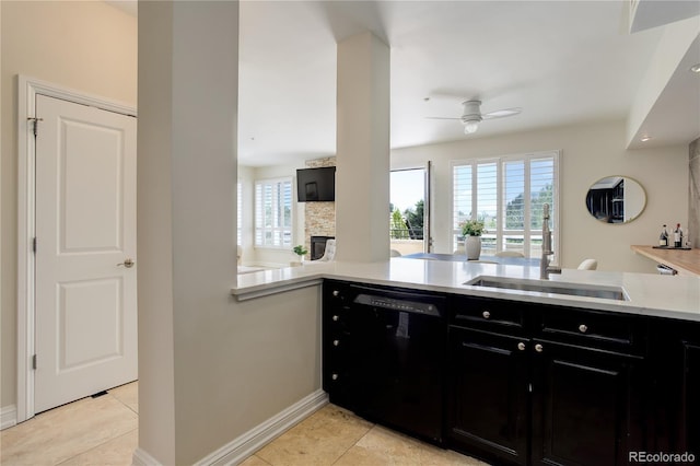 2500 E Cherry Creek S Drive 306, Denver, CO 80209 - kitchen featuring black dishwasher, dark cabinetry, a sink, ceiling fan, and a fireplace