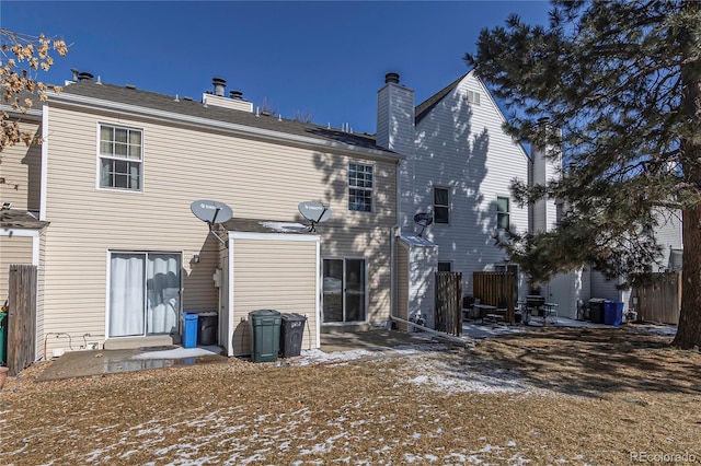 rear view of property with a patio and fence