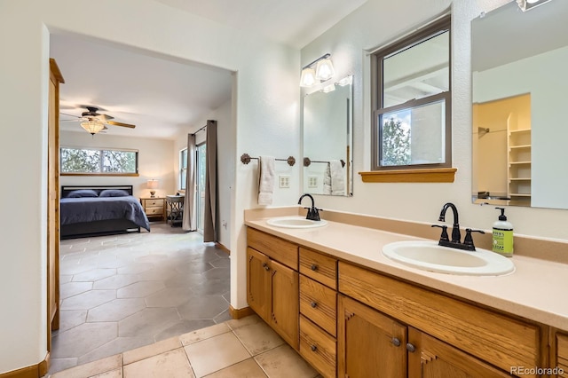ensuite bathroom featuring connected bathroom, tile patterned flooring, a ceiling fan, and a sink