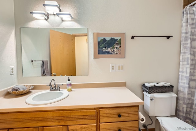 full bathroom with toilet and vanity