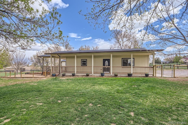 back of house with covered porch, a gate, fence, and a lawn