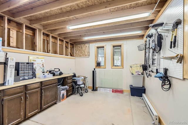 basement featuring baseboards and baseboard heating