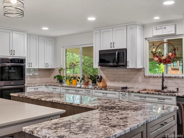 6166 S Dover St, Littleton, CO 80123 - kitchen featuring double oven, tasteful backsplash, white cabinetry, and recessed lighting