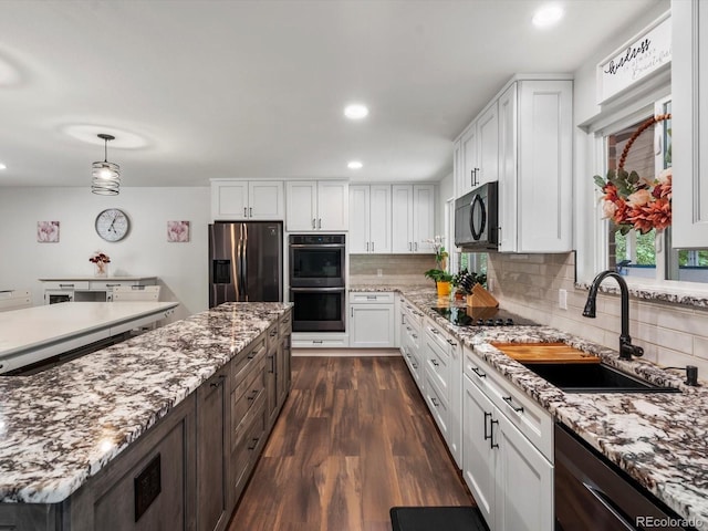 6166 S Dover St, Littleton, CO 80123 - kitchen featuring black appliances, white cabinetry, backsplash, dark wood-style floors, and recessed lighting