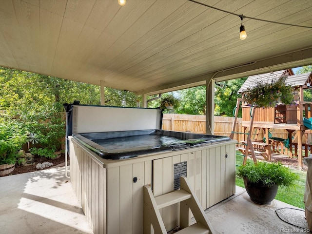 6166 S Dover St, Littleton, CO 80123 - view of patio / terrace with a hot tub and a playground