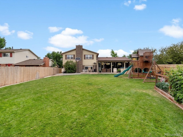 6166 S Dover St, Littleton, CO 80123 - fenced backyard with a playground and a patio