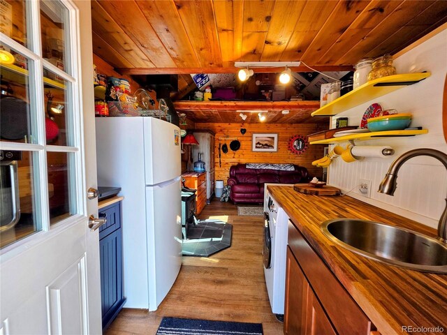 163 Ward St, Bailey, CO 80421 - kitchen with freestanding refrigerator, butcher block counters, wooden ceiling, a sink, and light wood-style flooring