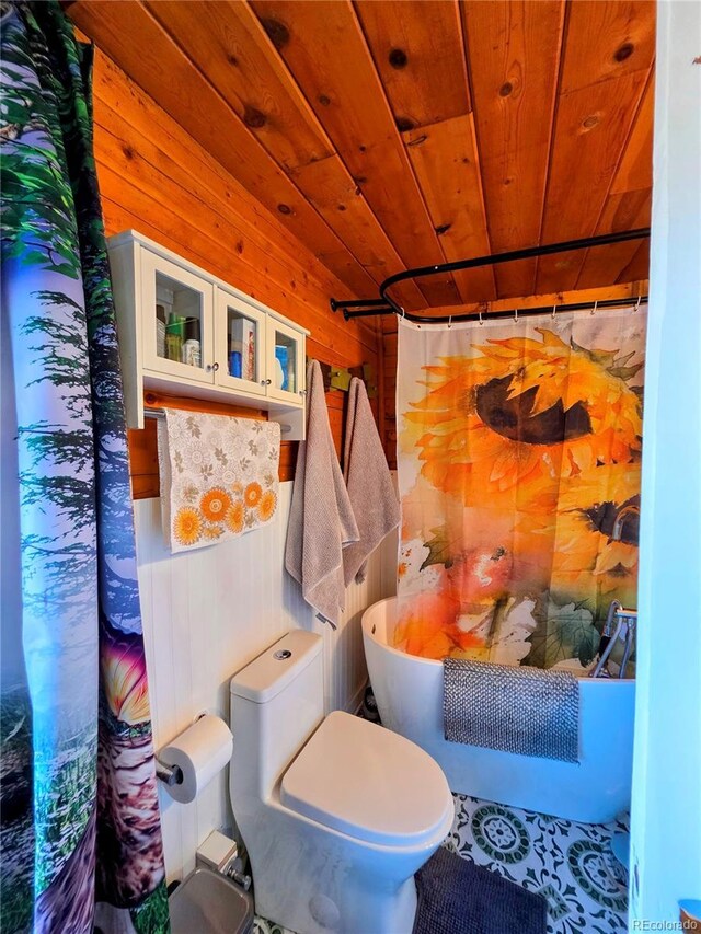 163 Ward St, Bailey, CO 80421 - bathroom featuring wood walls, curtained shower, toilet, a bathing tub, and wooden ceiling