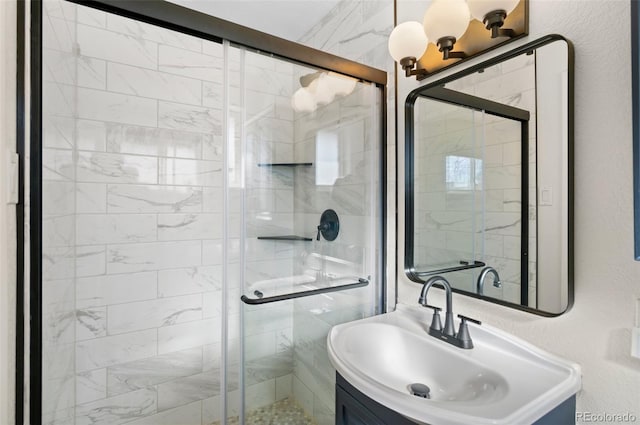 bathroom with vanity and a shower with shower door