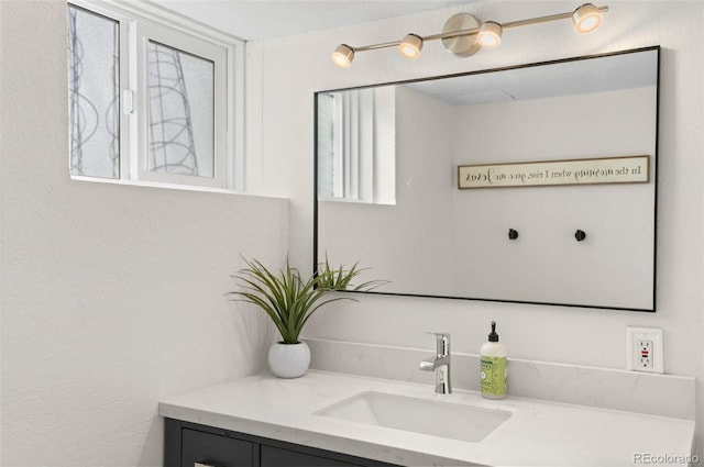 bathroom with vanity and a healthy amount of sunlight