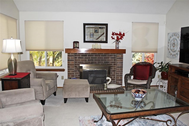 carpeted living room featuring vaulted ceiling and a brick fireplace