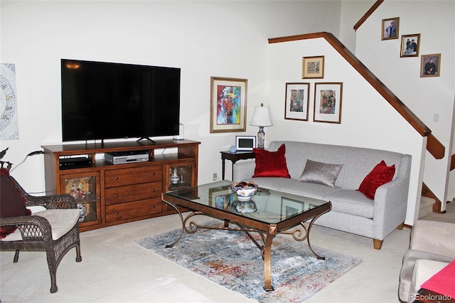 living area with carpet and stairway