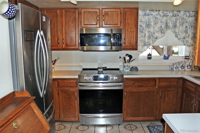 kitchen with stainless steel appliances and light tile patterned floors