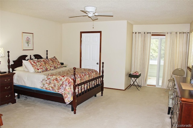 bedroom featuring access to outside, a textured ceiling, light colored carpet, and ceiling fan