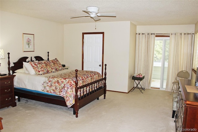 bedroom featuring light colored carpet, a textured ceiling, a ceiling fan, and access to exterior