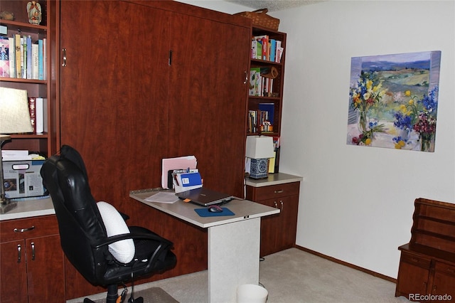 office featuring baseboards and light colored carpet