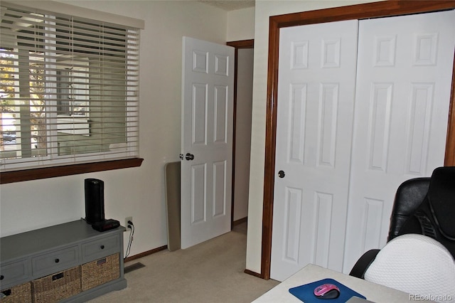 office featuring light colored carpet, visible vents, and baseboards