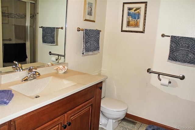 bathroom with an enclosed shower, toilet, baseboards, and vanity