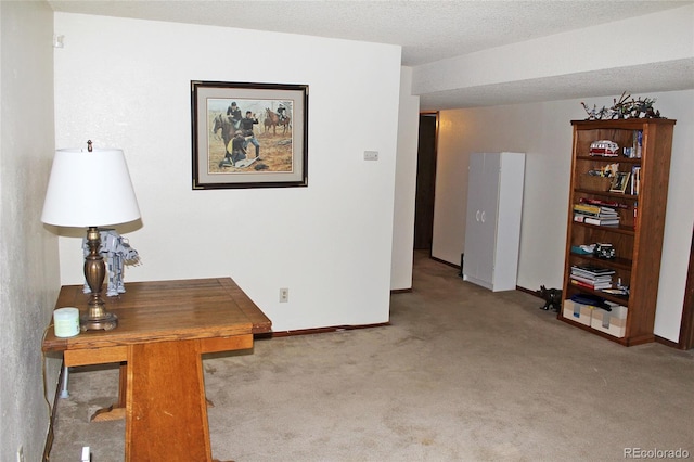 hallway with a textured ceiling and light colored carpet