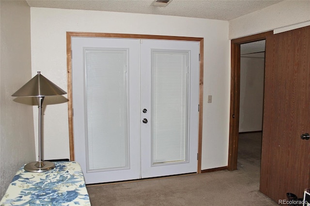 carpeted bedroom with a closet and french doors