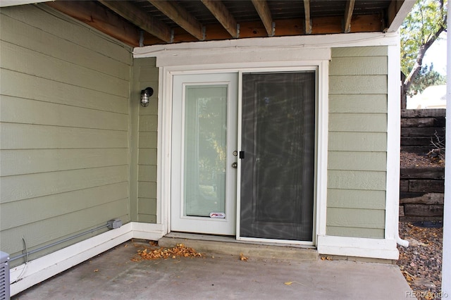 view of exterior entry with fence