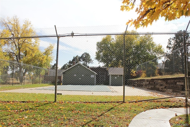 view of tennis court featuring fence