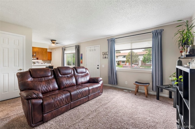 1216 S Uvalda St, Aurora, CO 80012 - living room with light carpet, a ceiling fan, and a textured ceiling