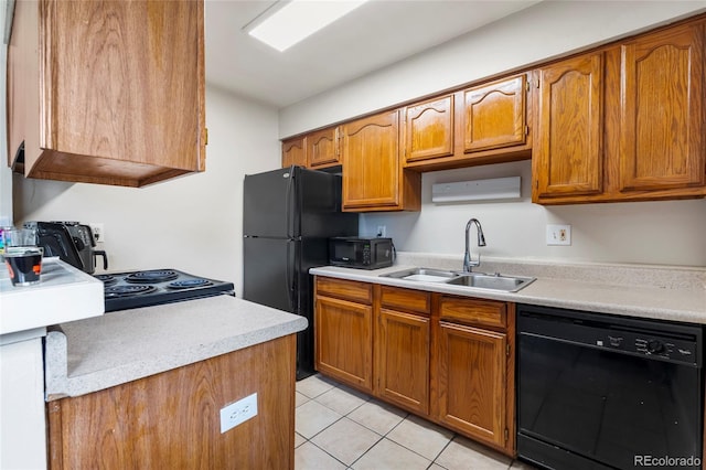 1216 S Uvalda St, Aurora, CO 80012 - kitchen featuring black appliances, a sink, light countertops, and brown cabinetry