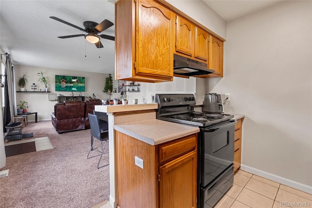 1216 S Uvalda St, Aurora, CO 80012 - kitchen with electric range, under cabinet range hood, ceiling fan, open floor plan, and light countertops