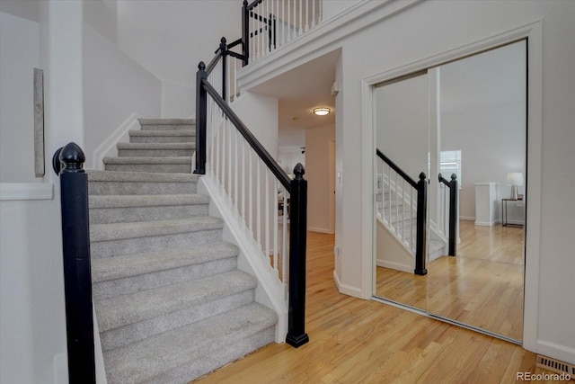 stairway with hardwood / wood-style flooring