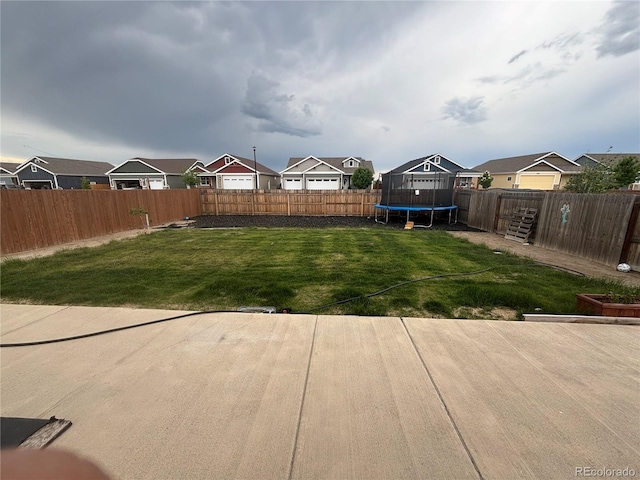 509 Pronghorn Ct, Wiggins, CO 80654 - fenced backyard with a trampoline and a residential view